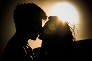 man and woman kissing