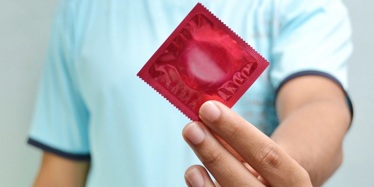 man holding a condom